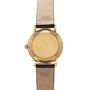 Gold-tone Universal Genève wristwatch with round case, cream dial, and two-tone leather strap.