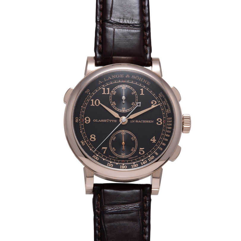 A.Lange & Söhne chronograph watch with black dial, Arabic numerals, two subdials, and dark leather strap.