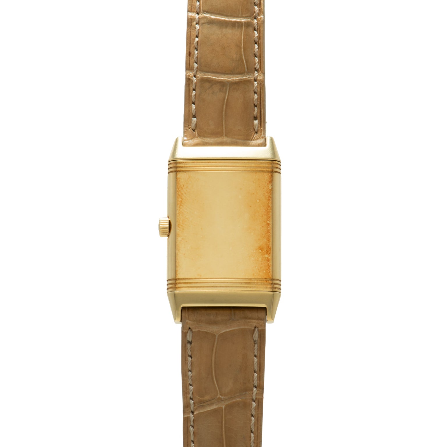 Gold-tone rectangular watch with tan crocodile leather strap and crown on side.