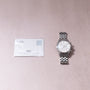 IWC Pilot's Chronograph Spitfire with stainless steel bracelet and white dial, displayed with warranty card.