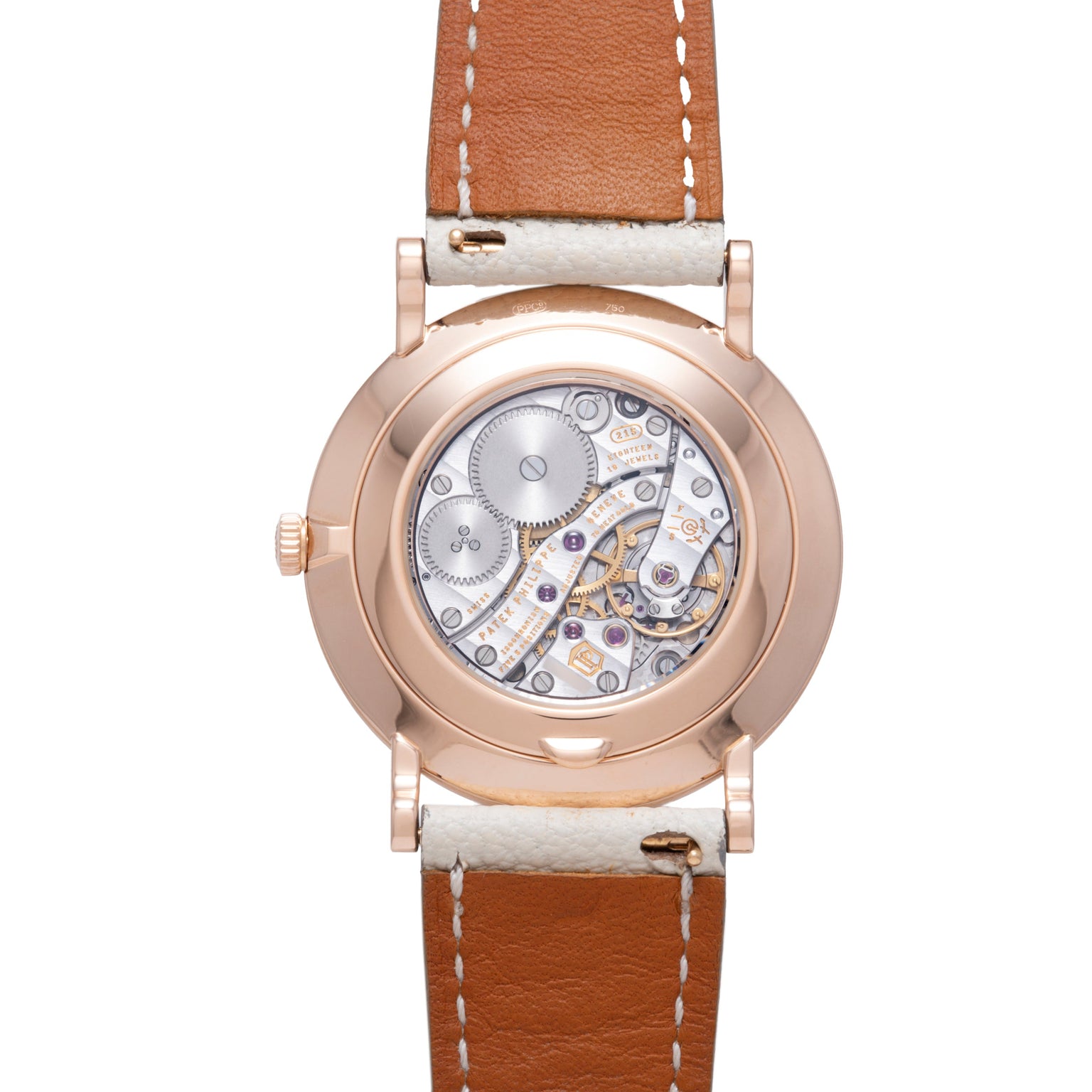 Rose gold watch with transparent caseback revealing mechanical movement, tan leather strap with white stitching.
