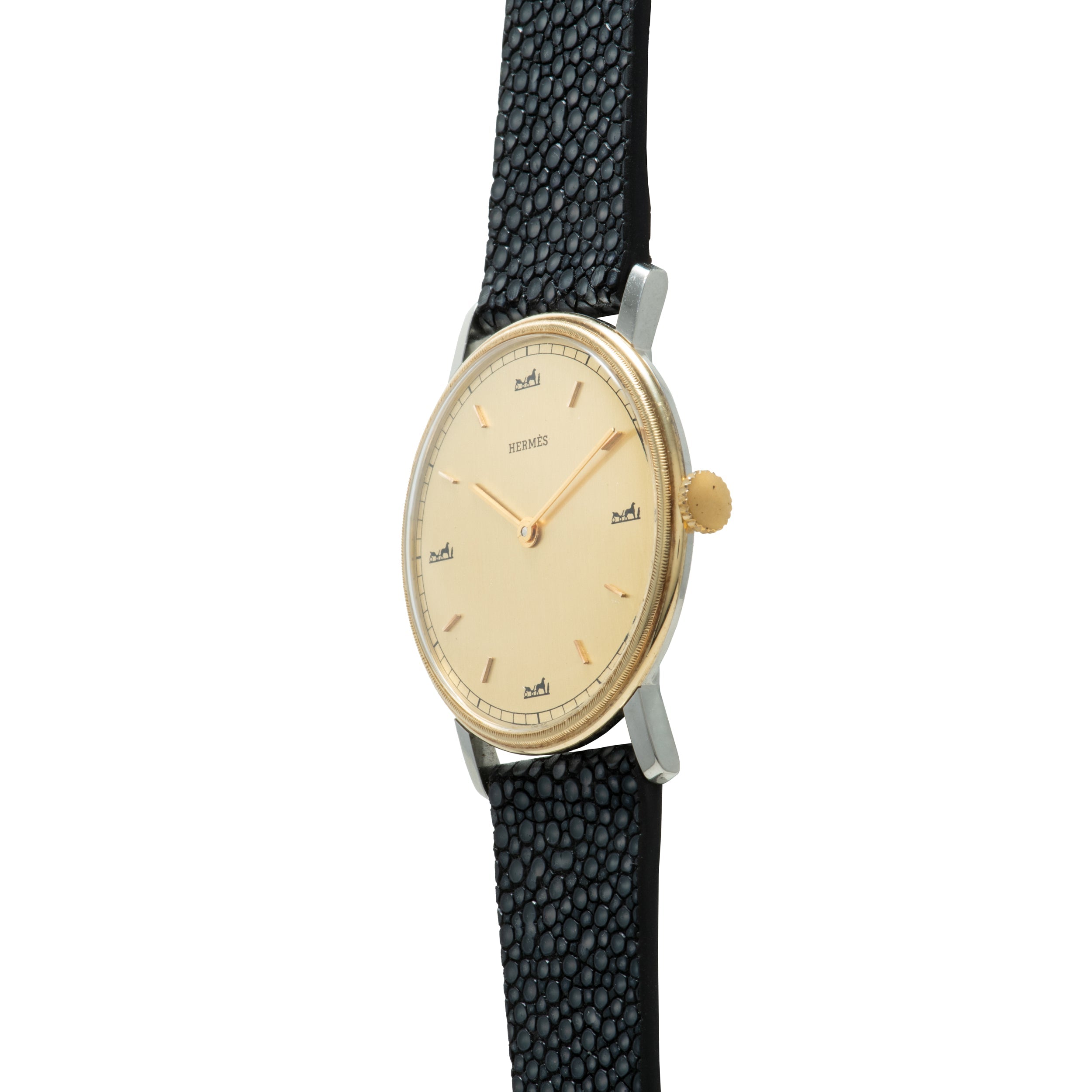 Hermès wristwatch with cream dial, gold-tone case, gold crown, and black textured leather strap.