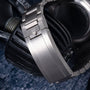 Steel bracelet and clasp detail of Tudor Pelagos 39 watch displayed on dark fabric.