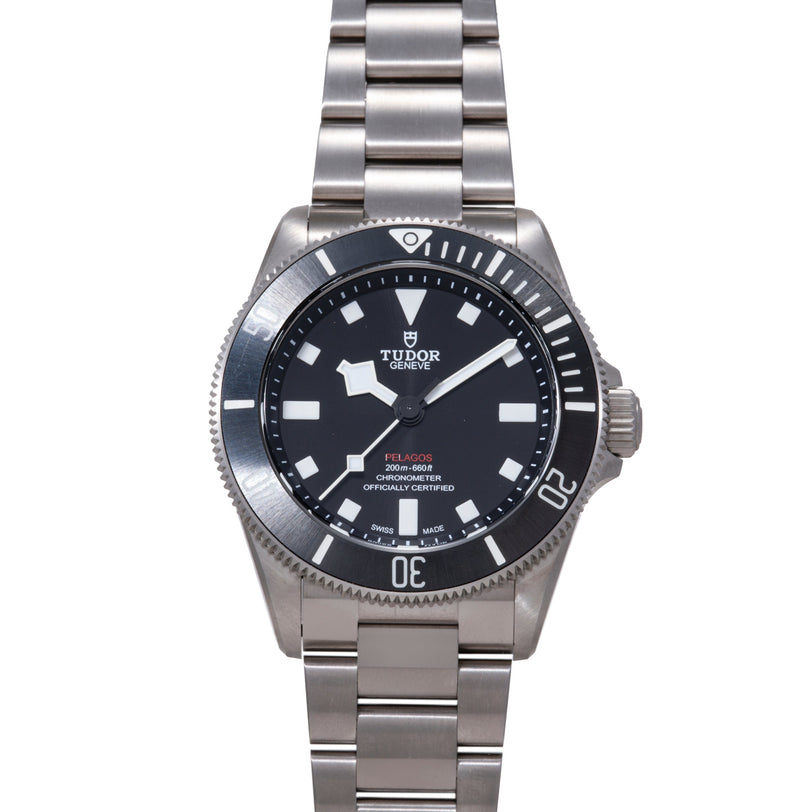 Tudor Pelagos 39 stainless steel watch with black dial, white hour markers, and matching steel bracelet.