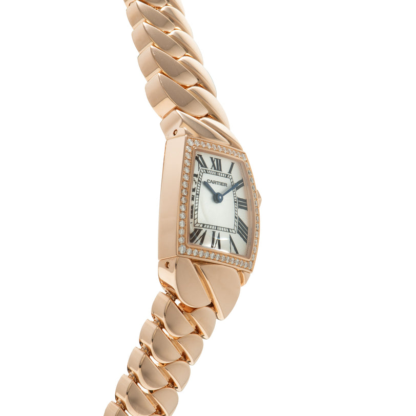 Rose gold Cartier watch with curved rectangular dial, white face, Roman numerals, diamond-set bezel, and matching curved link