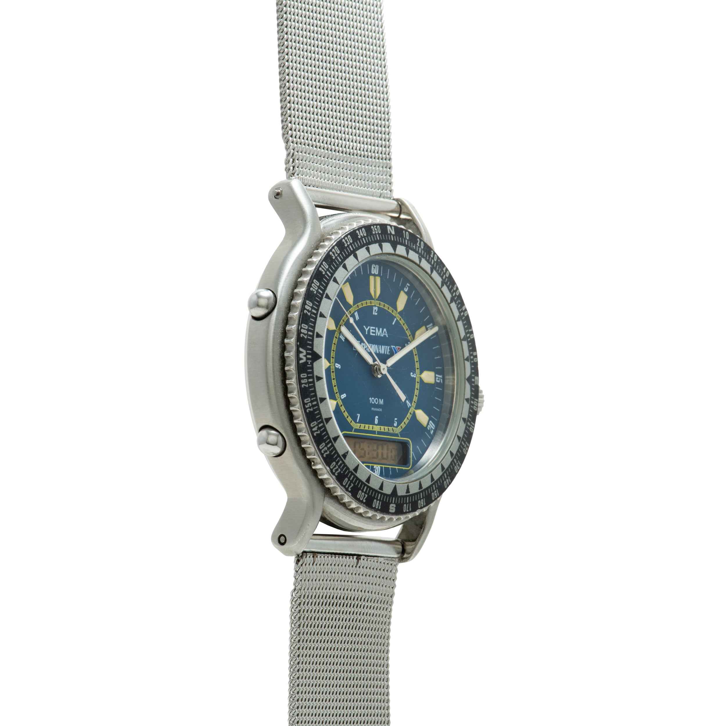 Yema Spationaute ISS watch with blue dial, yellow markers, rotating bezel, and stainless steel mesh band.