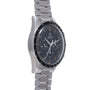Stainless steel chronograph watch with black dial, orange accents, tachymeter bezel, and matching bracelet.