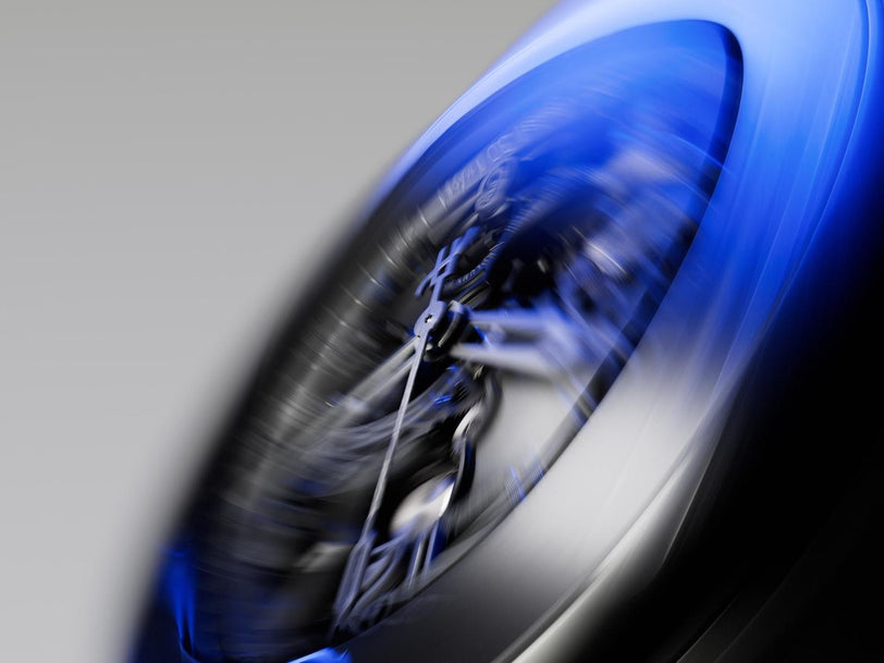 Blue ceramic vessel with dynamic swirl pattern and gradient fade from blue to white and black.