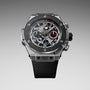 Stainless steel and black ceramic chronograph watch with exposed skeleton dial, red accents, and black rubber strap.
