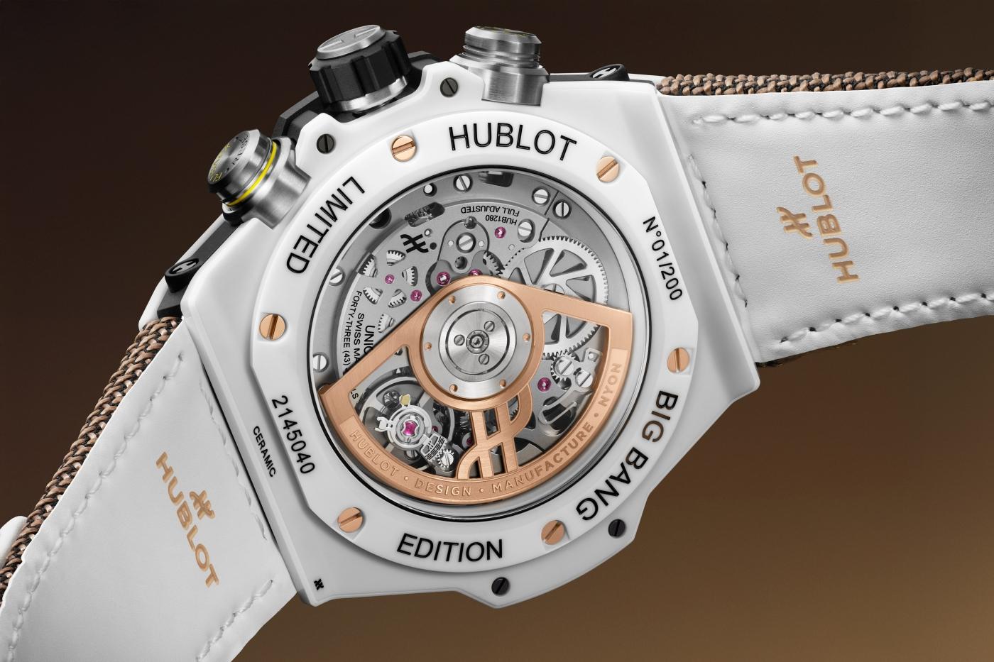 White ceramic Hublot Big Bang chronograph watch with exposed rose gold movement, white leather strap, and multiple subdials.