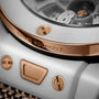 White ceramic watch with rose gold bezel, "Trust Yourself" text, and portrait visible in dial window.