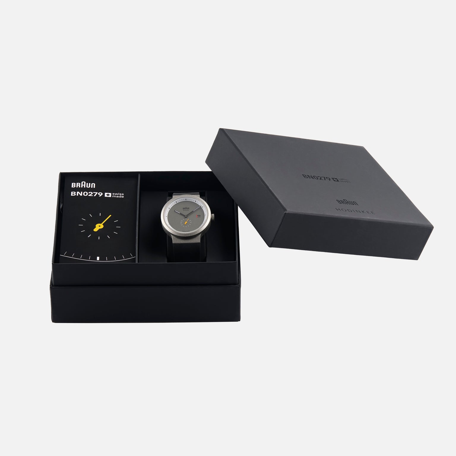 The Braun BN0279 Sub-Seconds Limited Edition For Hodinkee wristwatch and booklet are displayed in a black Braun gift box, with the lid set to the side.