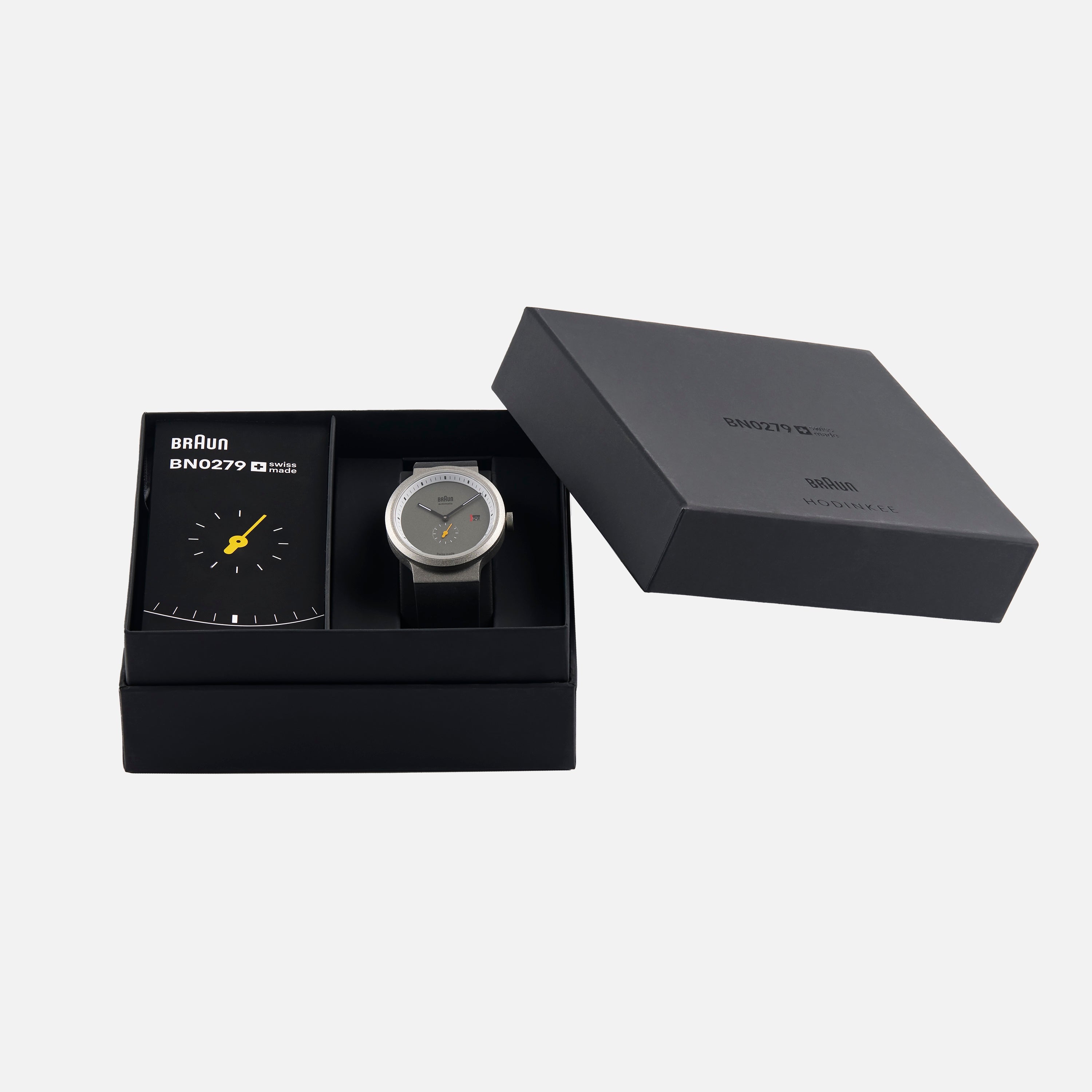 The Braun BN0279 Sub-Seconds Limited Edition For Hodinkee wristwatch and booklet are displayed in a black Braun gift box, with the lid set to the side.
