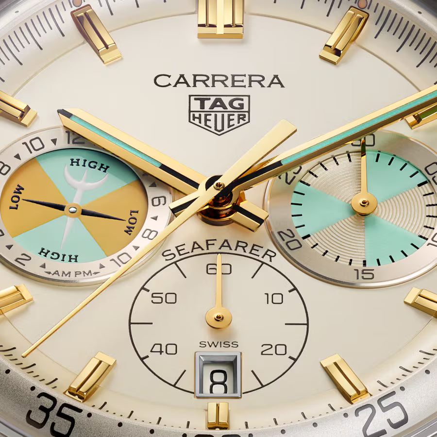 Close-up of a Tag Heuer Carrera watch face with gold and silver accents.