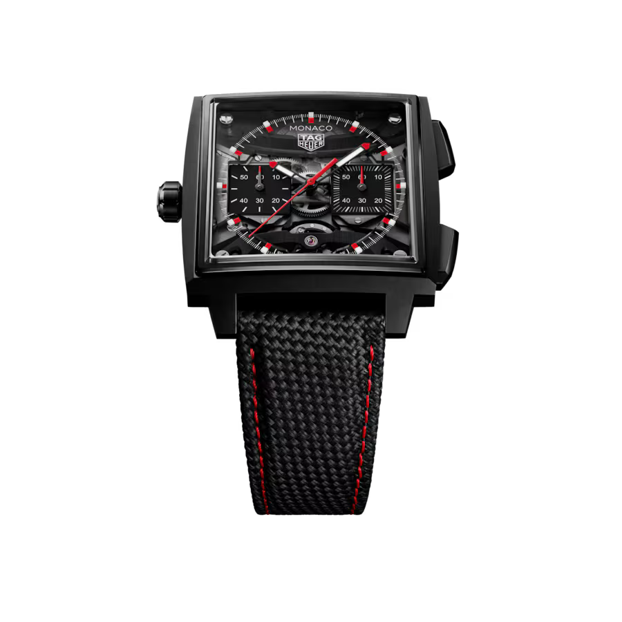 Black rectangular watch with chronograph subdials, red accents, and black woven strap with red stitching.