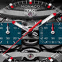 TAG Heuer Monaco Evergraph watch face with red and white hands, teal subdials, and visible internal mechanical components.