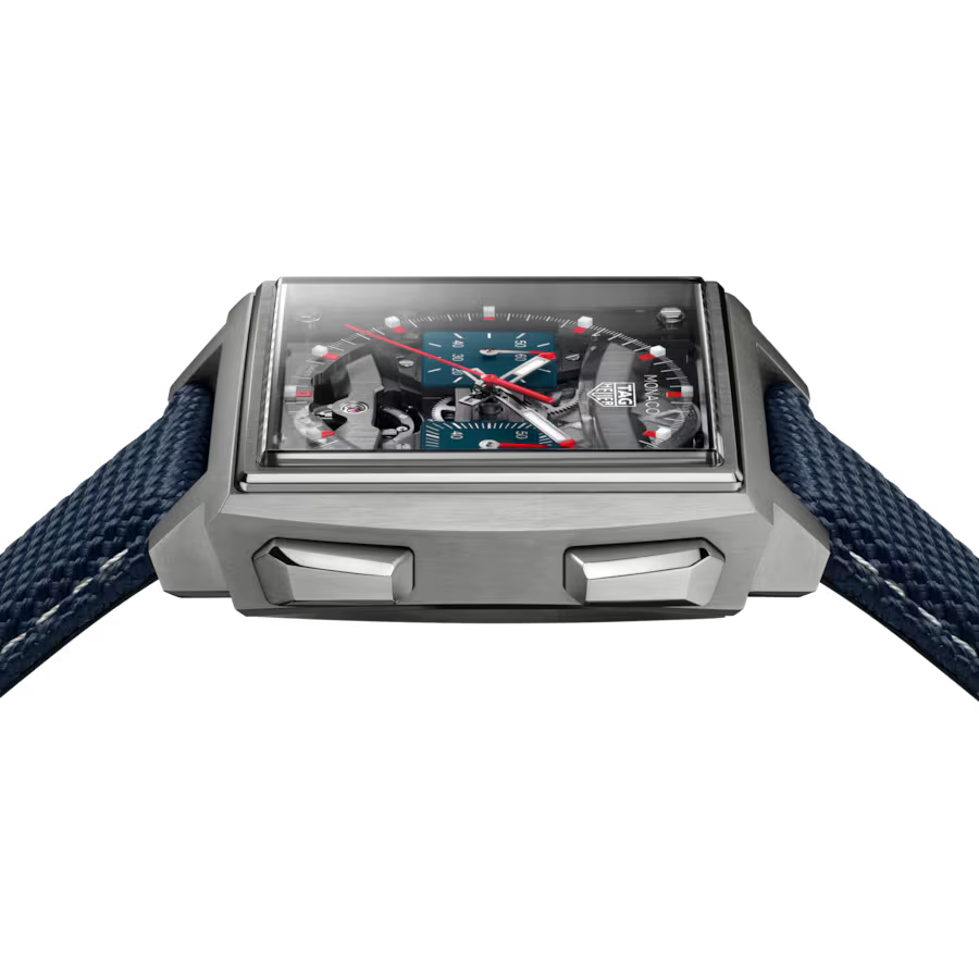 Rectangular watch with gray metal case, dark blue fabric strap, and rectangular dial featuring blue face with red hands and v
