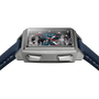 Rectangular watch with gray metal case, dark blue fabric strap, and rectangular dial featuring blue face with red hands and v