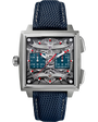 Square stainless steel chronograph watch with teal subdials, red hands, and visible movement, navy textile strap.