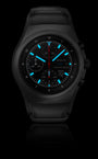 The Porsche Design Chronograph 1 Utility Limited Edition is a black wristwatch with blue luminous markers and hands, featuring date, day, and chronograph functions.