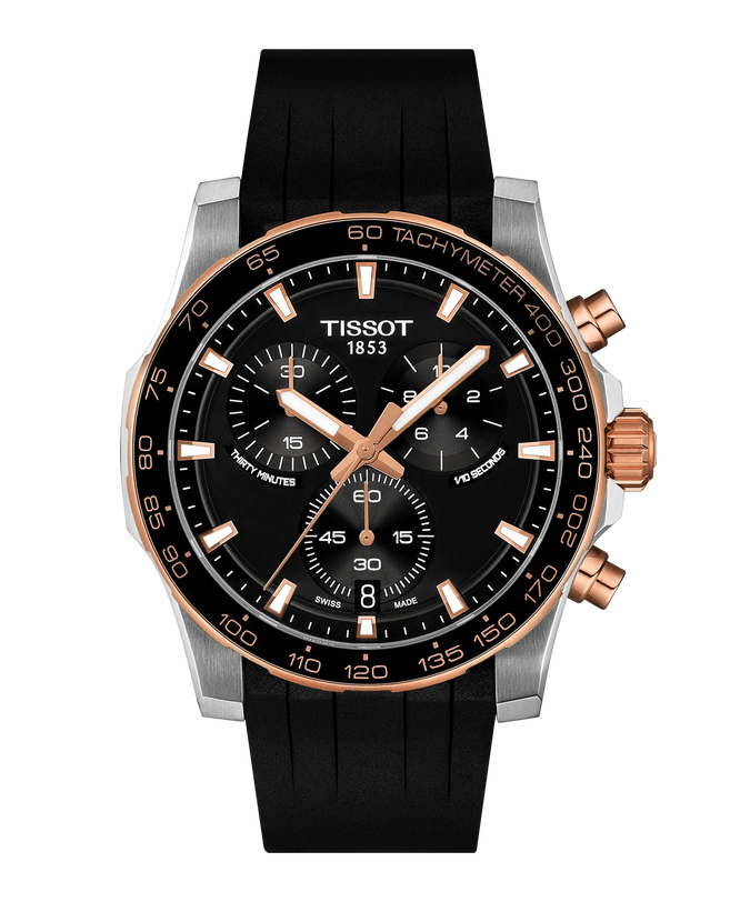 Stainless steel chronograph watch with black dial, rose gold accents, black rubber strap, and tachymeter bezel.