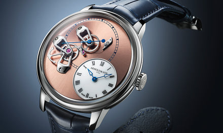 Luxury watch with a rose gold dial, exposed mechanics, and blue leather strap on a dark background.