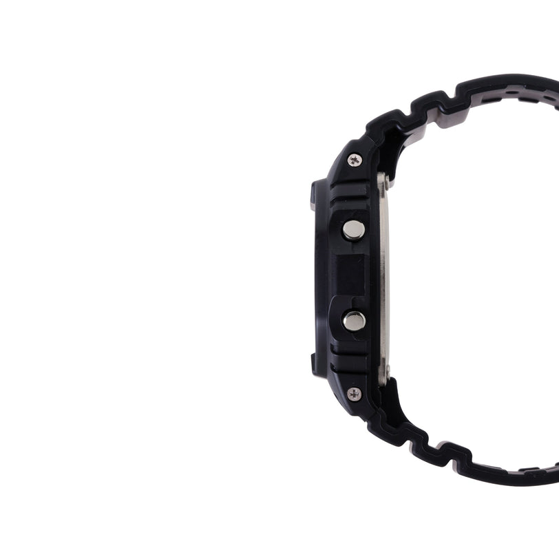 Black digital watch with textured resin case, square face, metal buttons, and matching black resin band shown from side view.