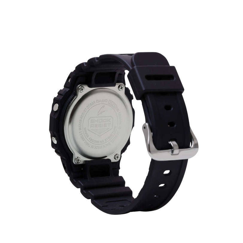 Black digital watch with round silver case back, black resin band, and metal buckle shown from rear angle.