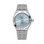 Stainless steel watch with light blue dial, applied hour markers, date window, and matching bracelet.