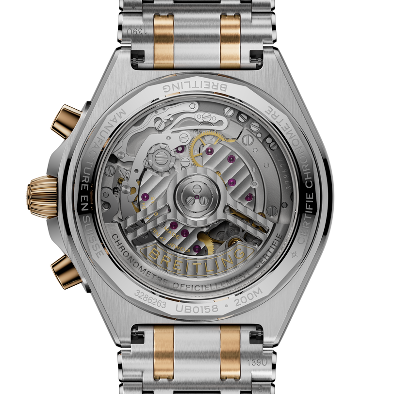 Chronomat B01 42 watch with two-tone steel and gold bracelet, showing exposed movement through transparent caseback with visi