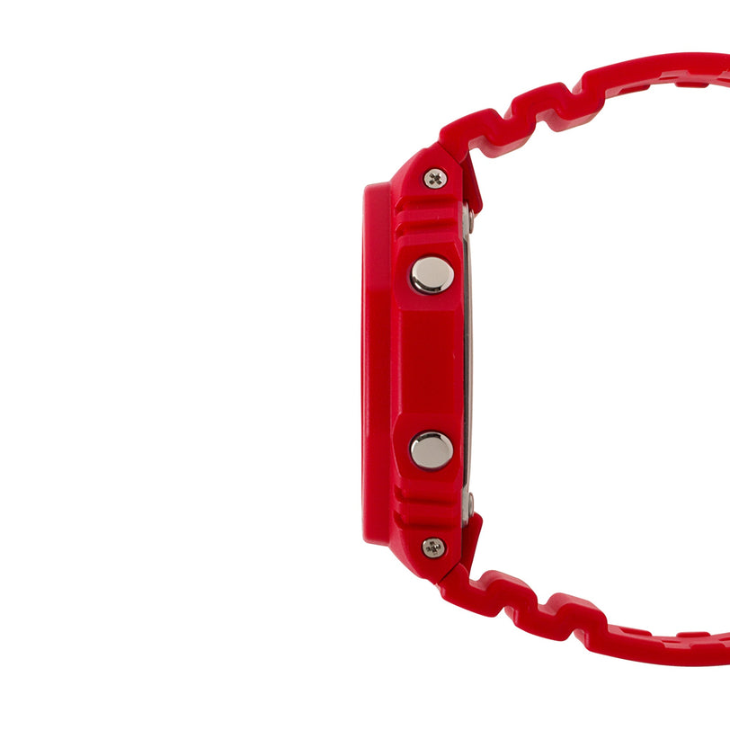 Red resin digital watch with square case, metal buttons, and textured band shown from side view.