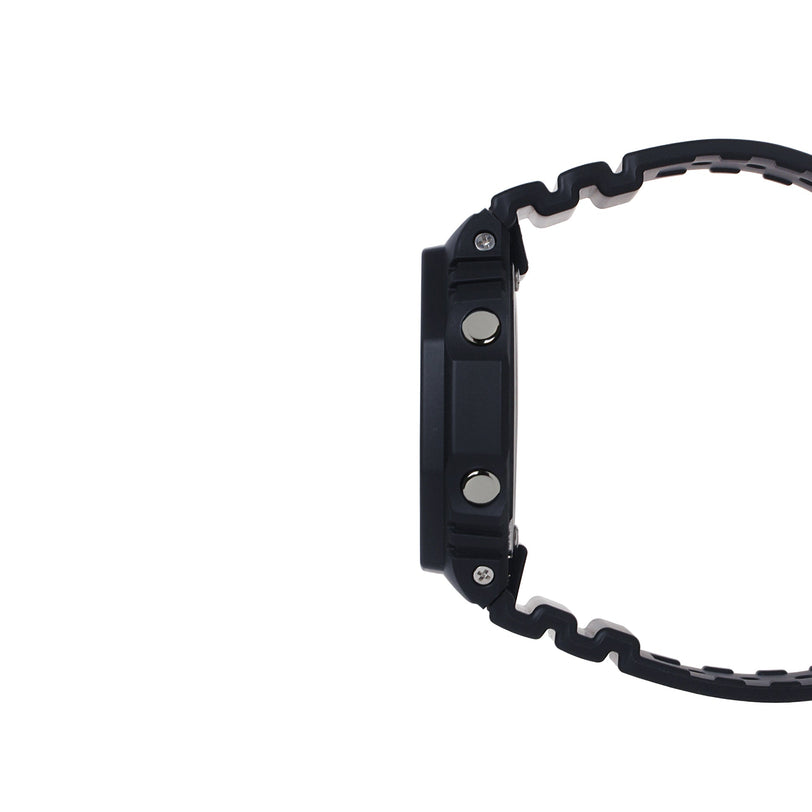 Black digital watch with square resin case and textured rubber strap, shown from the side.