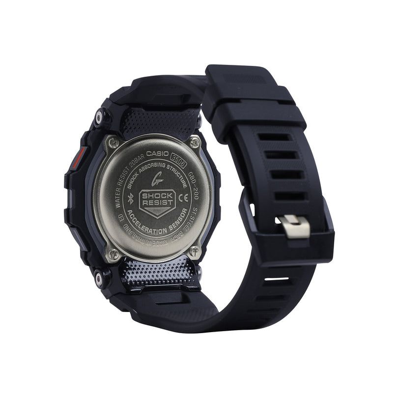 Black digital watch with square face, resin band, and metal caseback featuring shock resist branding.