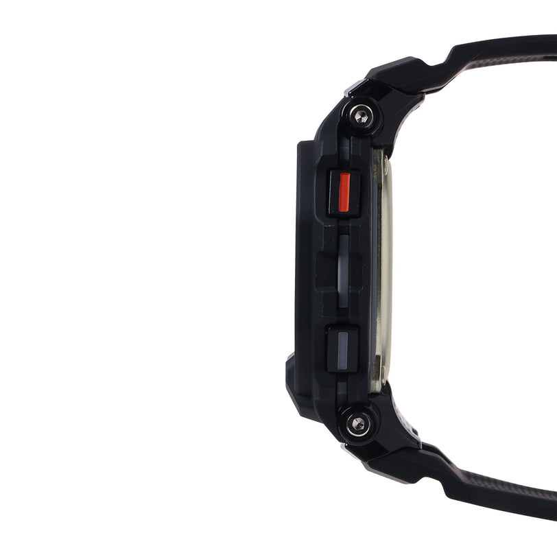 Black digital watch with square face, red accent button, and black resin band shown from side view.
