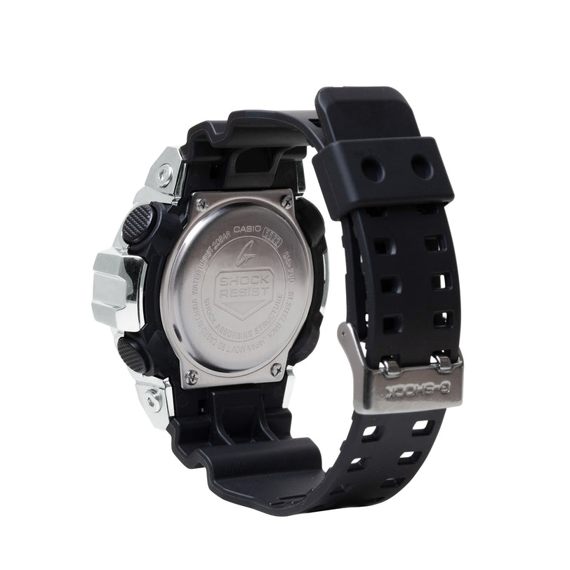 Digital watch with silver stainless steel case, black resin band, and rectangular face shown from back view.
