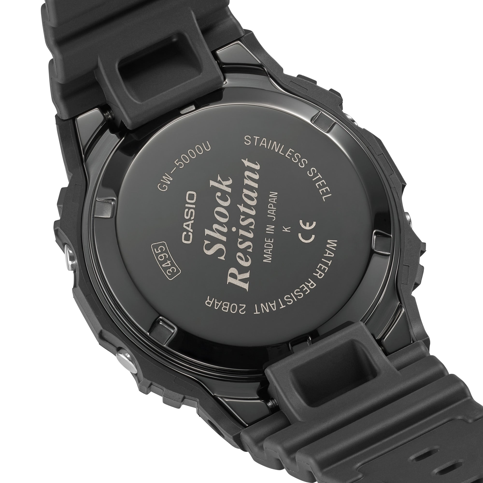 Black resin digital watch with stainless steel caseback displaying model GW-5000U specifications and solar icon.