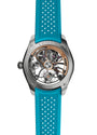 Back view of the H. Moser & Cie Pioneer Cylindrical Tourbillon Skeleton Spiced Aqua, showcasing visible gears and a vibrant blue perforated rubber strap.
