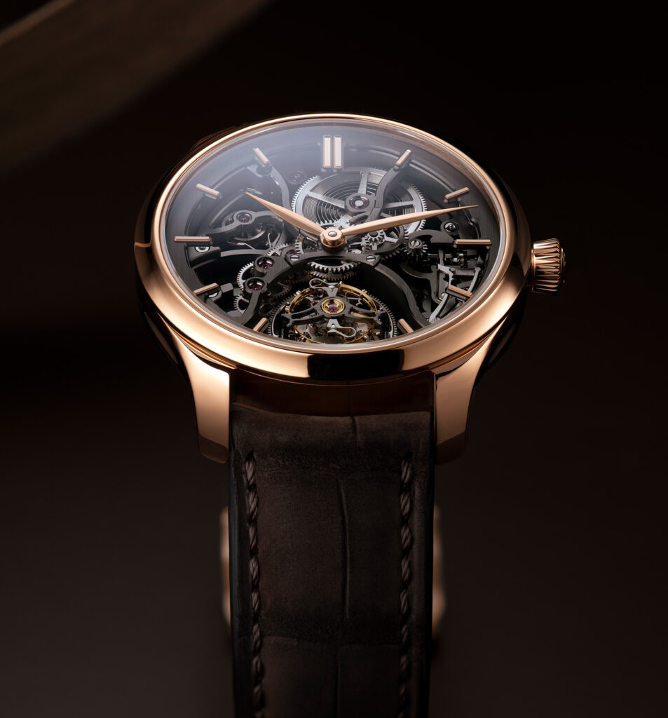 Luxury watch with black leather strap and rose gold case on a dark background