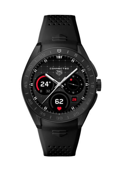The TAG Heuer Connected Calibre E5 45mm is a luxury smartwatch with a black perforated rubber strap, round face, and digital display showing time, heart rate, temperature, and date.