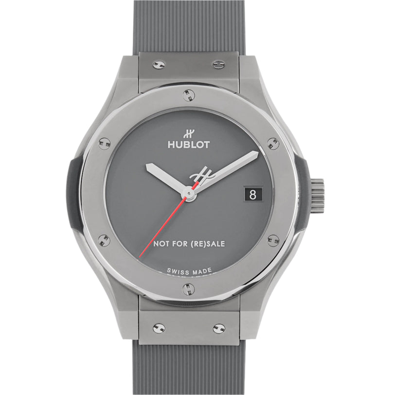 A gray Hublot Classic Fusion Titanium Limited Edition For Hodinkee wristwatch with a round face, date at 3 o’clock, red second hand, and NOT FOR (RE)SALE on the dial—created through a special Hublot collaboration.
