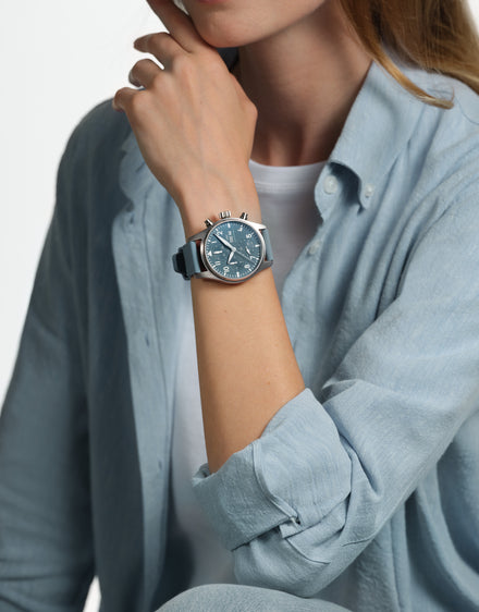 Woman wearing blue IWC watch wearing a blue outfit