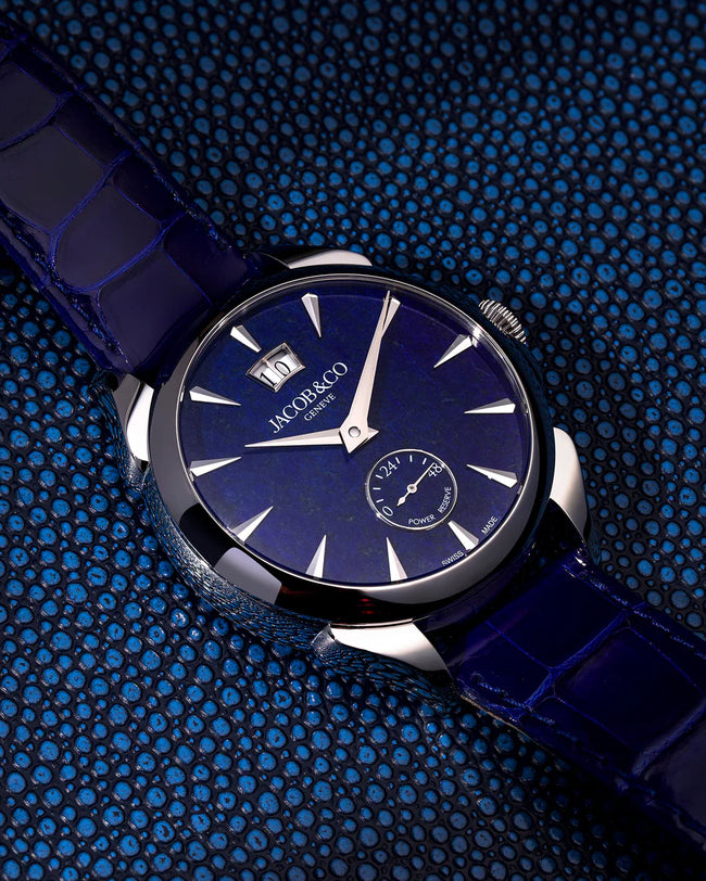 Jacob & Co watch with dark blue dial, silver hour markers, and matching blue crocodile leather strap.