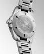 Close-up of a silver watch with brand engraving on a light gray background