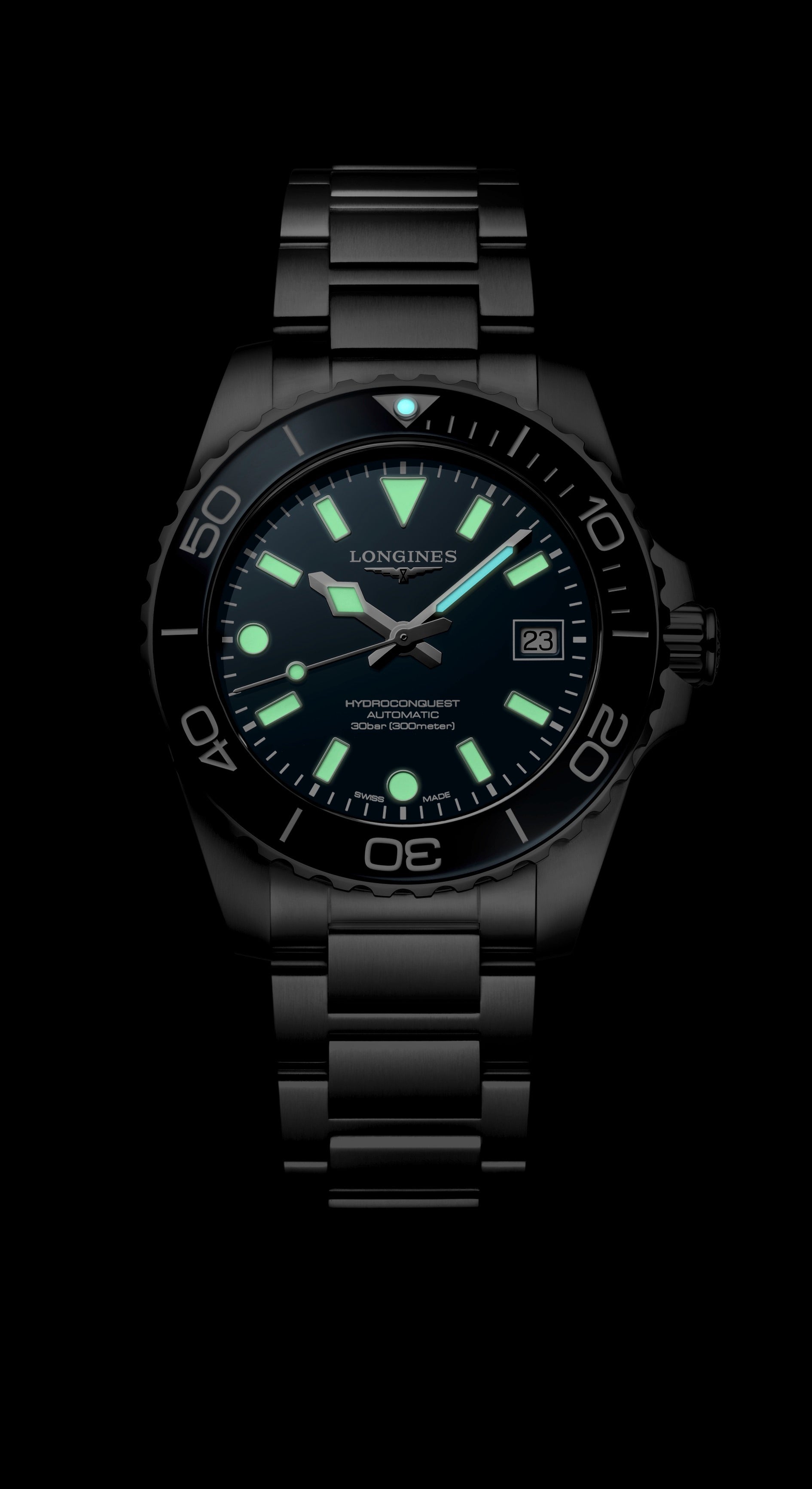 Black wristwatch with glowing green face on a black background