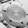 Close-up of a watch case with 'Longines' branding and details.