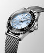 Silver watch with a detailed face on a light gray background