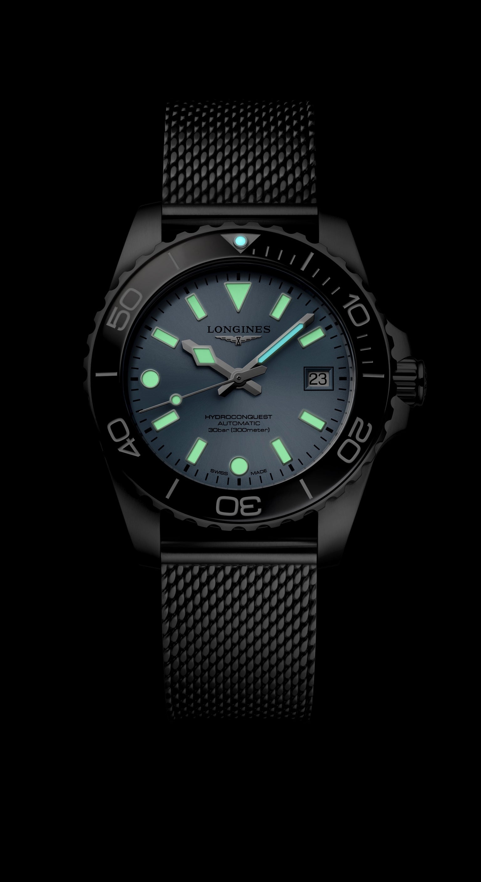 Black wristwatch with glowing green hands and markers on a black background
