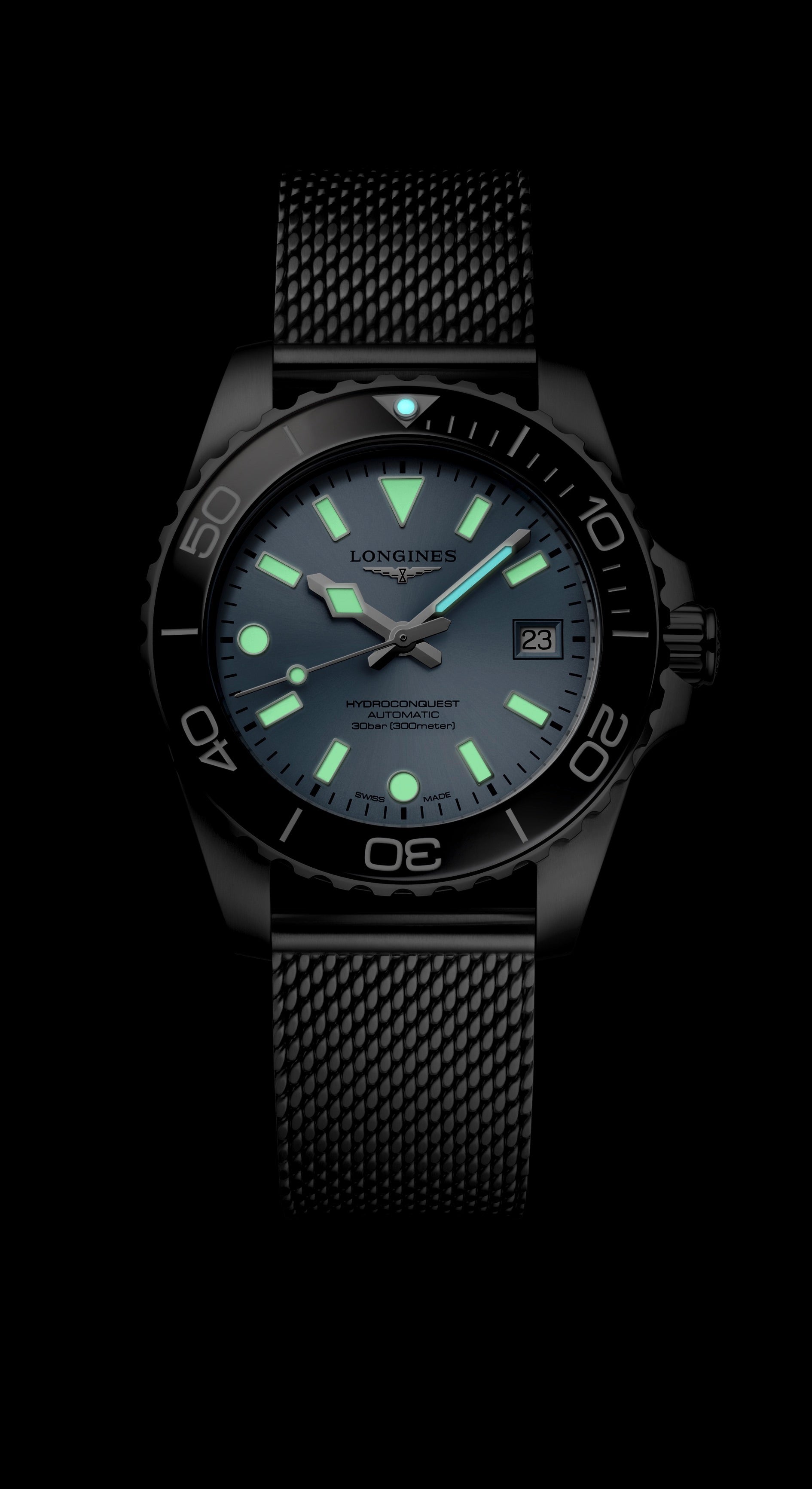 Black wristwatch with glowing green hands and markers on a black background