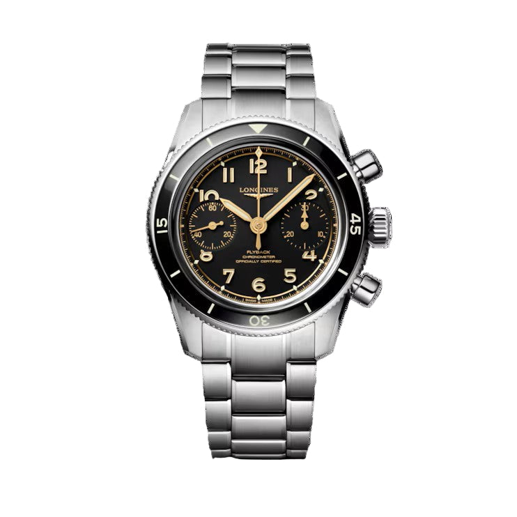 The Longines Spirit Pilot Flyback is a stainless steel wristwatch with a black dial, gold numerals, two subdials, and a metal link bracelet. It features a chronometer-certified movement and is shown against a white background.