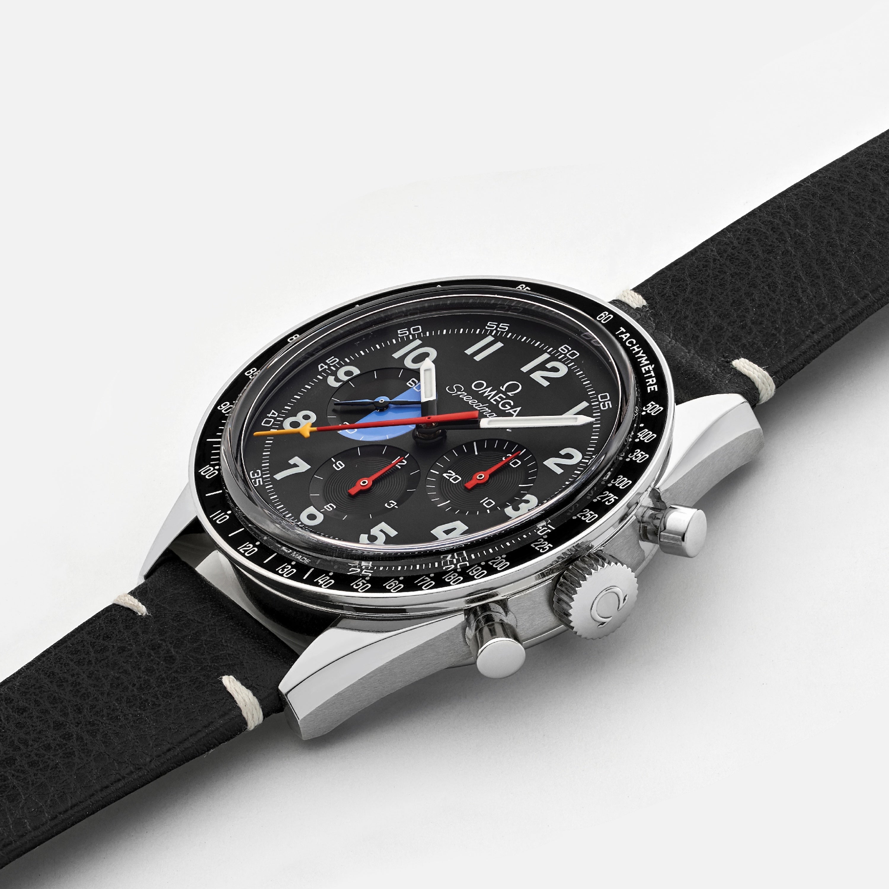 The OMEGA Speedmaster Hodinkee 10th Anniversary Limited Edition chronograph wristwatch features a black leather strap, silver case, and multiple dials with precise movement, shown on a plain white background.